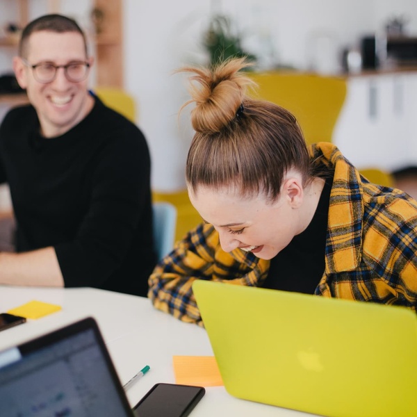 girl laughing while using computer